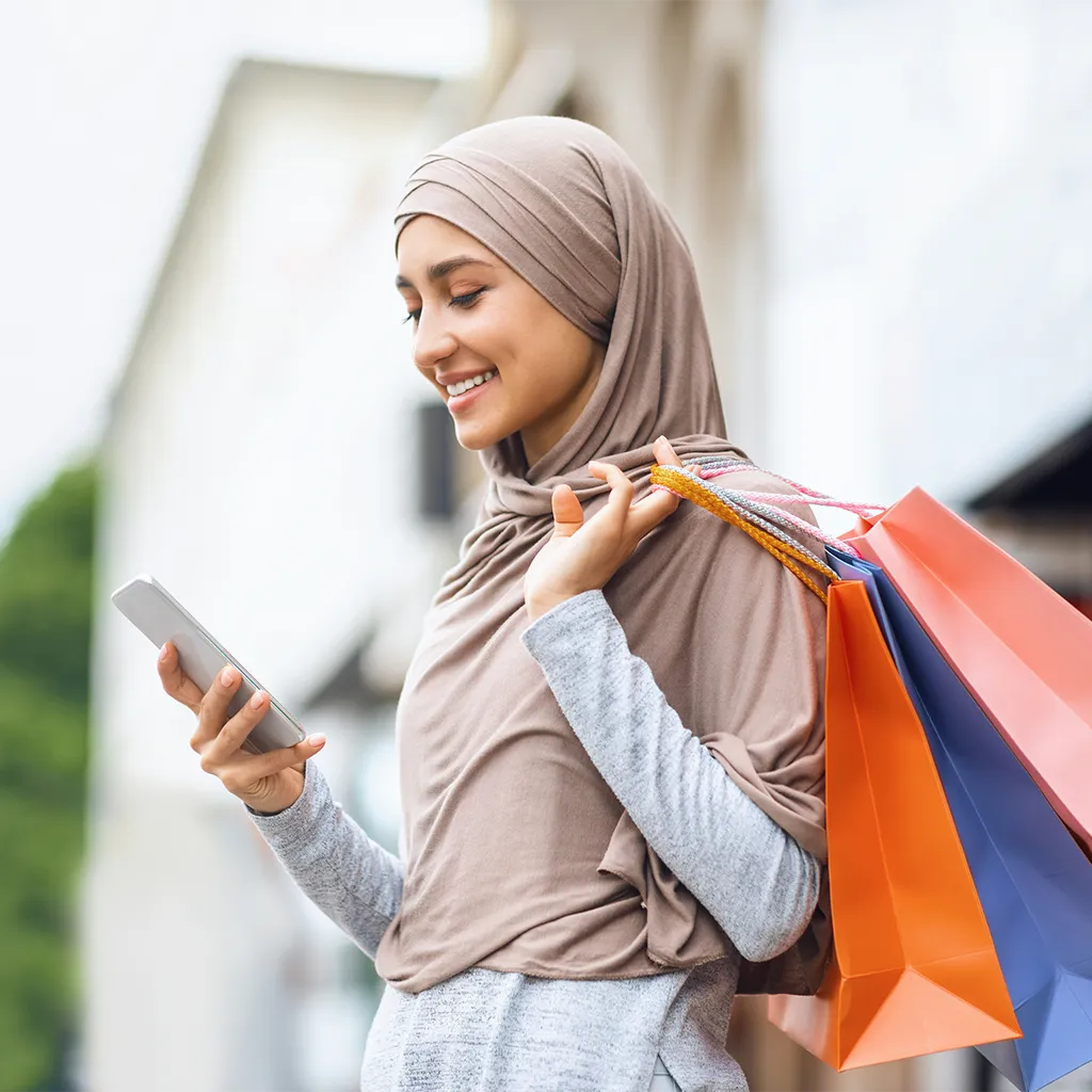 Woman with shopping bags on phone