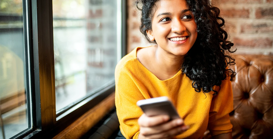 Woman with card smiling