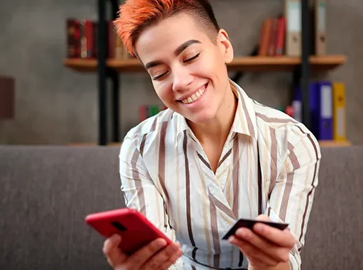 Young person entering card details into phone